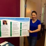 Alex Guo holds her posterboard.