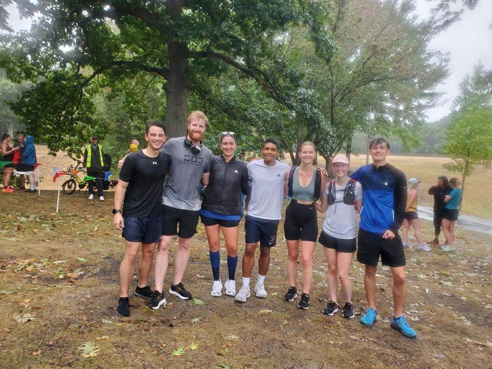 Seven runners smile at the camera