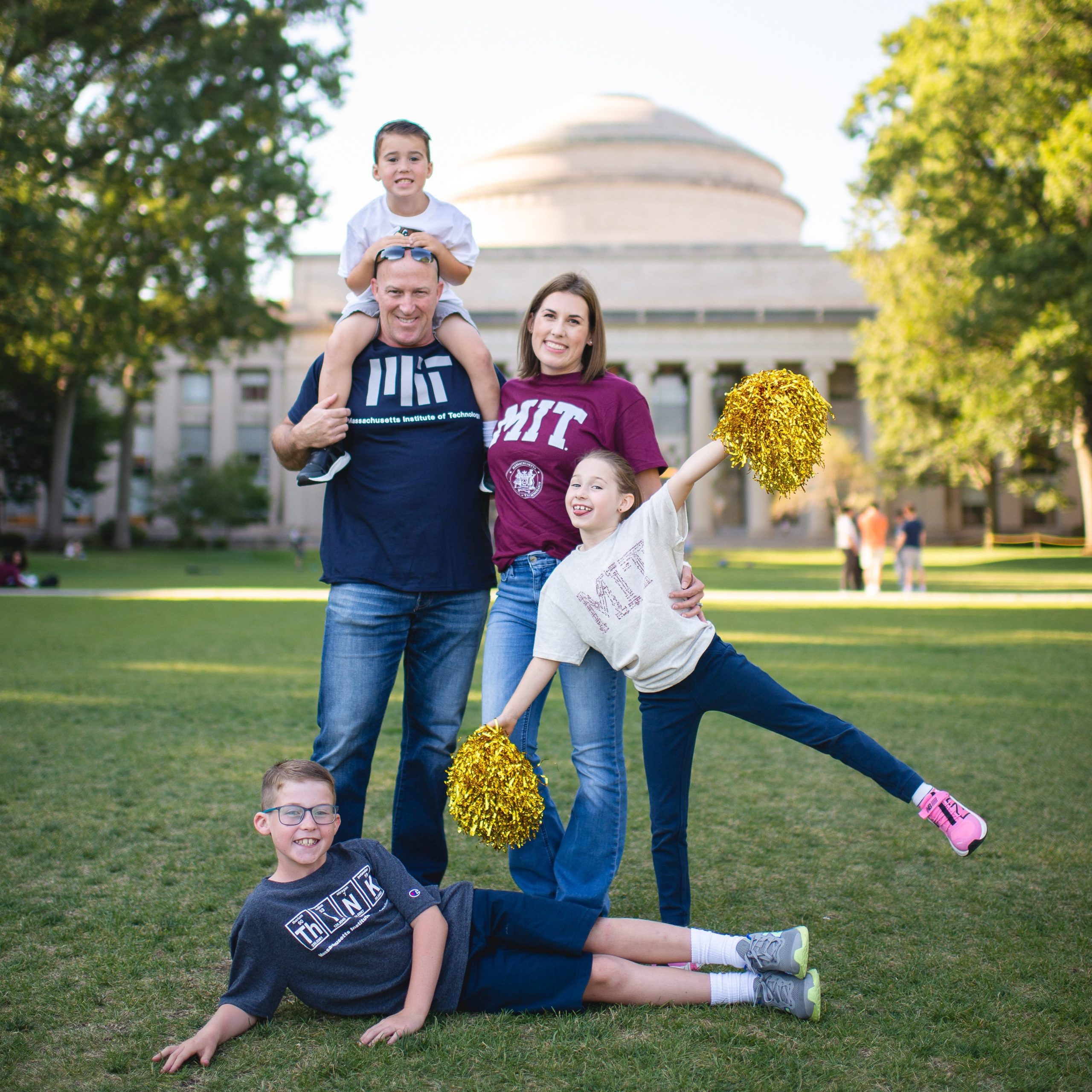 Allison's family stands in front of the MIT Dome, smiling.